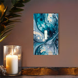 single switch plate featuring acrylic pour artwork print in blue, gray and navy by Primal Painter above a shelf with a candle