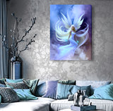 beautiful angel art by Primal Painter with a pale blue dress,white wings and hair floating in blue, purple, and white clouds as a stretched canvas print hanging over a couch