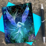 Blue, purple, and black ethereal angel art  greeting card with art nouveau flourishes and a feathery border by Primal Painter with blue envelope