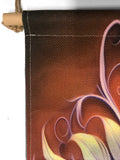 Fringed canvas wall hanging featuring artwork by Primal Painter of art nouveau foliage in rust, orange, and violet with the affirmation Be Kind to All Things closeup