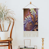 Fringed canvas wall hanging featuring artwork by Primal Painter of art nouveau foliage in rust, orange, and violet with the affirmation Be Kind to All Things hanging on a wall