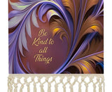 Fringed canvas wall hanging featuring artwork by Primal Painter of art nouveau foliage in rust, orange, and violet with the affirmation Be Kind to All Things.