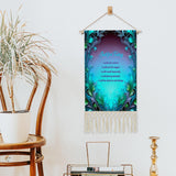 Fringed canvas wall hanging with a blue and green feather art nouveau border featuring the Reiki Principles text by Primal Painter hanging next to a chair