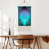 Fringed canvas wall hanging with a blue and green feather art nouveau border featuring the Reiki Principles text by Primal Painter hanging over a table