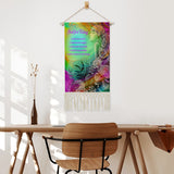 fringed canvas wall hanging featuring rainbow artwork of a flower child by Primal Painter and the Reiki Principles hanging over a table