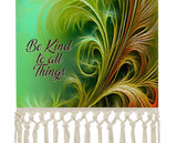 Fringed canvas wall hanging with feathery foliage artwork in greens and rust colors by Primal Painter and the affirmation "Be Kind to All Things" close up of fringe and text